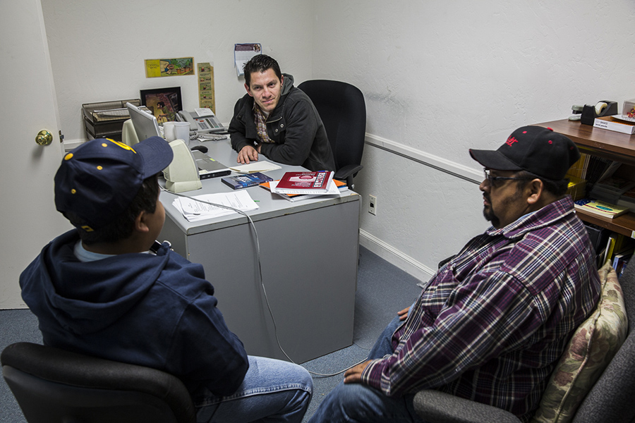 Counselor talks with two men