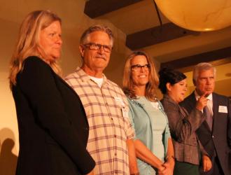 Grantees on stage for a photo op