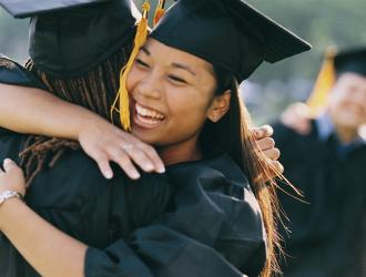Childrens Academy graduates happily hugging