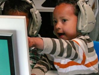Mobile Waterford: Boy with headphones pointing at computer screen