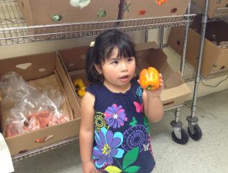 Catholic Charities: food pantry with little girl customer