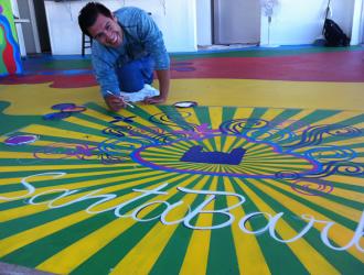 Youth Interactive: young artist painting sunburst on floor