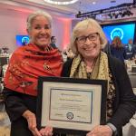  Suzi Schomer and Carolyn Jabs hold a framed Community Dividends certificate