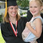 SBCC Single Parent Achievement Program: graduate with her daughter in her arms