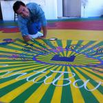 Youth Interactive: young artist painting sunburst on floor