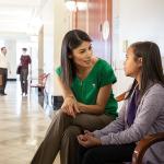 woman speaking with child outside courtroom