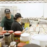 Two adults prepping food